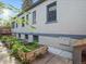 The home's backyard has garden beds with lush greenery at 386 Colorado Blvd, Denver, CO 80206