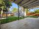 Spacious backyard features lush green grass, a garage, a stained fence, and a covered patio at 386 Colorado Blvd, Denver, CO 80206