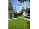 Backyard features a stained fence, detached garage, covered patio, lush green lawn, and outdoor seating at 386 Colorado Blvd, Denver, CO 80206