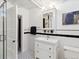 Stylish bathroom with white tile, black accents, a glass shower door, and a pedestal sink with vintage charm at 386 Colorado Blvd, Denver, CO 80206