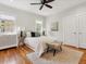 Bright bedroom featuring hardwood floors, neutral decor, and large windows at 386 Colorado Blvd, Denver, CO 80206