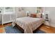 Cozy bedroom with wood floors, area rug, stylish bedding, and plenty of natural light at 386 Colorado Blvd, Denver, CO 80206