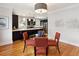 Bright dining room with hardwood floors, modern chandelier, glass table and open to the kitchen at 386 Colorado Blvd, Denver, CO 80206