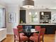 Dining area with stylish lighting fixture, open to modern kitchen with stainless appliances at 386 Colorado Blvd, Denver, CO 80206