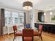 Charming dining room featuring a modern chandelier, round glass table, and large windows at 386 Colorado Blvd, Denver, CO 80206