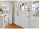Welcoming foyer with original door, gleaming hardwood floors, and ample natural light at 386 Colorado Blvd, Denver, CO 80206