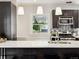 Modern kitchen with a breakfast bar, stainless steel appliances, and stylish mosaic backsplash at 386 Colorado Blvd, Denver, CO 80206