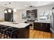 Open kitchen with a breakfast bar, stainless steel appliances and modern dark cabinets at 386 Colorado Blvd, Denver, CO 80206