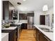 Bright, modern kitchen with stainless steel appliances and sleek, dark cabinetry at 386 Colorado Blvd, Denver, CO 80206