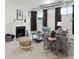 Cozy living room boasts a fireplace, comfortable seating, neutral tones, and soft carpeting for a relaxing atmosphere at 386 Colorado Blvd, Denver, CO 80206