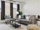 Inviting living room with soft gray sofa, stylish cushions and a small table, bathed in natural light from nearby windows at 386 Colorado Blvd, Denver, CO 80206
