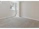 Neutral room with gray carpet, white walls, built-in shelves, and a bright window, ideal for versatile use at 386 Colorado Blvd, Denver, CO 80206