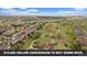 Stunning aerial view of a suburban neighborhood with lush green spaces and walking trails winding through the community at 7829 S Coolidge Way, Aurora, CO 80016