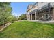 The backyard features a well maintained lawn, a covered patio and stone pillars at 7829 S Coolidge Way, Aurora, CO 80016