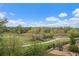 This is a view from the backyard showing a walking trail, lush greenery, and the surrounding landscape at 7829 S Coolidge Way, Aurora, CO 80016