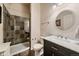 This bathroom features a glass enclosed shower, vanity with sink, and a round mirror at 7829 S Coolidge Way, Aurora, CO 80016