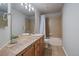 Bathroom with tiled counter and floors, a shower and bathtub, and a large mirror at 7829 S Coolidge Way, Aurora, CO 80016