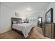 Bedroom featuring a large bed, dresser, mirror, and carpet flooring for comfortable living at 7829 S Coolidge Way, Aurora, CO 80016