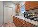 Well-lit counter space area with upper and lower cherry wood cabinets providing ample storage at 7829 S Coolidge Way, Aurora, CO 80016
