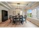 Elegant dining room featuring coffered ceilings, a modern light fixture, and a large window with outdoor views at 7829 S Coolidge Way, Aurora, CO 80016