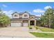 Charming two-story home featuring a stone facade, three-car garage, and well-manicured front lawn at 7829 S Coolidge Way, Aurora, CO 80016