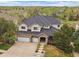 Charming two-story home features a three-car garage, stone accents, and a well-manicured lawn at 7829 S Coolidge Way, Aurora, CO 80016