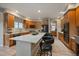 Well-lit kitchen with island featuring granite countertops and stainless steel appliances at 7829 S Coolidge Way, Aurora, CO 80016