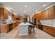 Large kitchen featuring granite countertops, an island with seating, and custom cabinetry at 7829 S Coolidge Way, Aurora, CO 80016