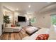 Open living area includes exercise equipment, contemporary furnishings, and sliding glass doors to outdoor space at 7829 S Coolidge Way, Aurora, CO 80016