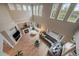 Bright living room features a fireplace, a vaulted ceiling, and many windows at 7829 S Coolidge Way, Aurora, CO 80016