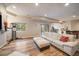 This open living space includes a home gym, sectional sofa, and convenient bar area for relaxation and entertainment at 7829 S Coolidge Way, Aurora, CO 80016