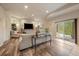 Bright living room with hardwood floors, large TV, and access to the outdoor patio at 7829 S Coolidge Way, Aurora, CO 80016