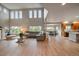 Expansive living room with soaring ceilings, large windows, hardwood floors, and an open floor plan at 7829 S Coolidge Way, Aurora, CO 80016