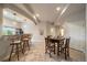 Open-concept space with a breakfast bar, dining area, and plenty of natural light from large windows at 7829 S Coolidge Way, Aurora, CO 80016