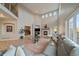 Bright living room with tall ceilings, fireplace, oversized windows, and a comfortable couch at 7829 S Coolidge Way, Aurora, CO 80016