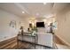 Spacious living room featuring a large television, workout equipment, and stylish decor at 7829 S Coolidge Way, Aurora, CO 80016