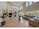 Bright living area featuring a fireplace, large windows, hardwood floors, and neutral decor at 7829 S Coolidge Way, Aurora, CO 80016