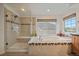 Bright bathroom features a separate shower and tub, a window, and tile floor at 7829 S Coolidge Way, Aurora, CO 80016