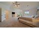 Bright main bedroom features a plush carpet, a ceiling fan, and large windows at 7829 S Coolidge Way, Aurora, CO 80016