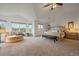 Spacious main bedroom boasts large windows, a seating area, and neutral carpet at 7829 S Coolidge Way, Aurora, CO 80016