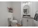 Bright powder room with hardwood floors, pedestal sink, and modern fixtures at 7829 S Coolidge Way, Aurora, CO 80016