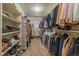 Walk-in closet with shelves, shoe racks, and rods for clothes at 7829 S Coolidge Way, Aurora, CO 80016