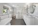 Bright bathroom featuring soaking tub, glass shower, and double vanity with marble countertop at 3811 E 26Th Avenue Pkwy, Denver, CO 80205