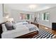 Bright bedroom featuring twin beds, hardwood floors, and large windows allowing for natural light at 3811 E 26Th Avenue Pkwy, Denver, CO 80205