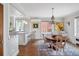 Open concept dining room and kitchen area with hardwood floors and modern fixtures at 3811 E 26Th Avenue Pkwy, Denver, CO 80205