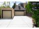 Spacious driveway leading to a two-car attached garage with an additional one-car detached garage at 3811 E 26Th Avenue Pkwy, Denver, CO 80205