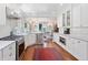 Open-concept kitchen with stainless steel appliances and stylish white cabinets at 3811 E 26Th Avenue Pkwy, Denver, CO 80205