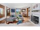 Bright living room featuring hardwood floors, white sofa, fireplace, and views of the outdoor landscape at 3811 E 26Th Avenue Pkwy, Denver, CO 80205