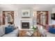 Cozy living room with a fireplace, hardwood floors, and comfortable seating, great for entertaining or relaxing at 3811 E 26Th Avenue Pkwy, Denver, CO 80205