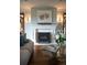 Charming living room featuring a decorative fireplace, hardwood floors, and comfortable seating, perfect for relaxing at 3811 E 26Th Avenue Pkwy, Denver, CO 80205
